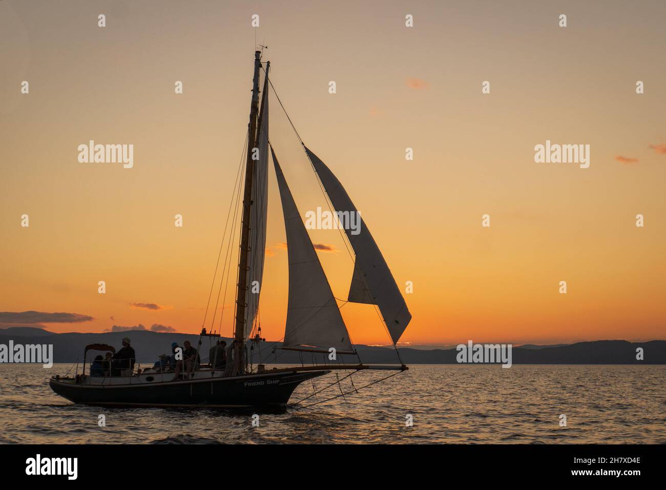 historic  gaff-rigged 'Friendship' sloop at sunset on Lake Champlain, Burlington, Vermont Stock Photo