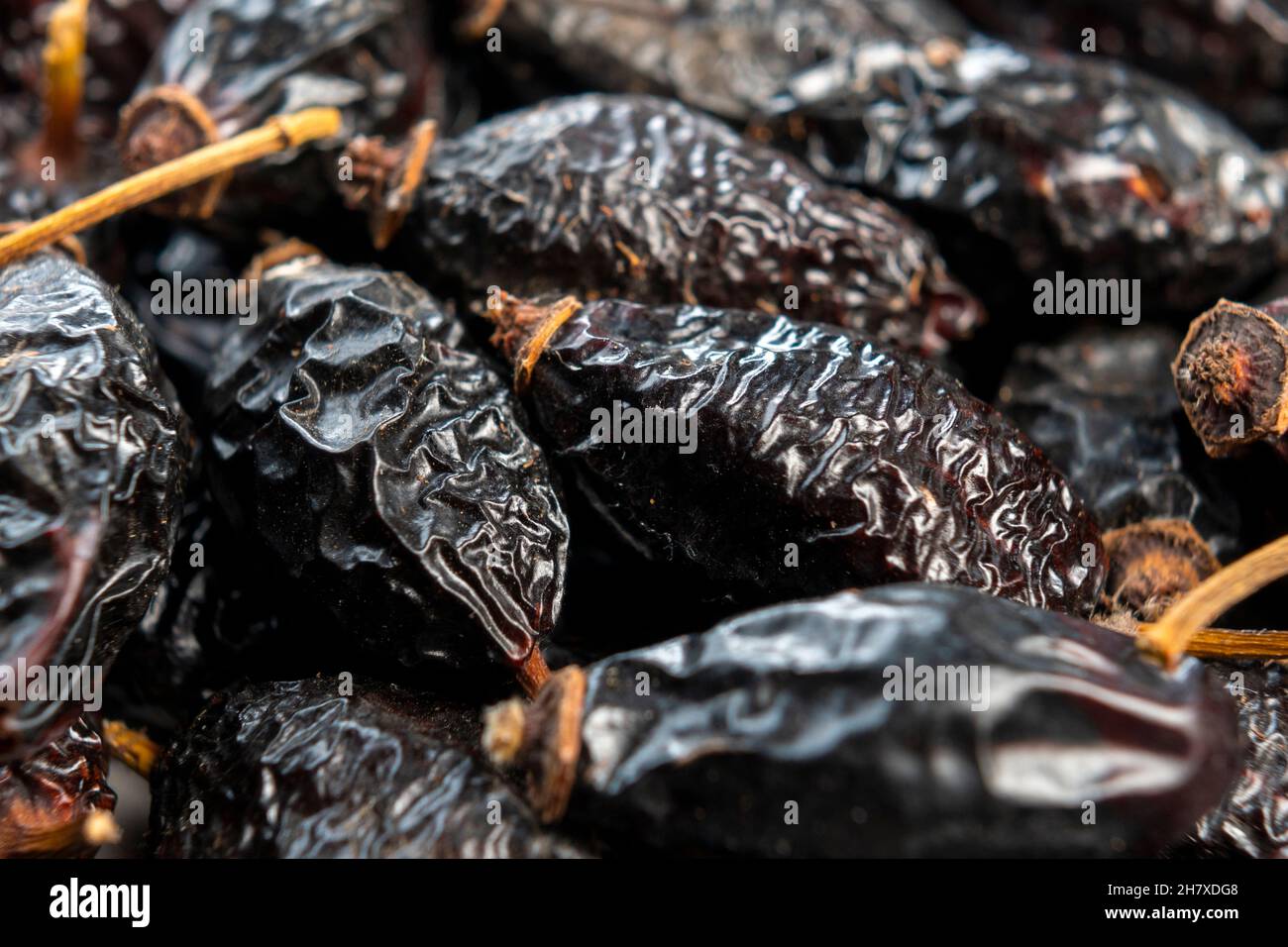 Dry rose hips. Dried wrinkled briar berries. Dog-rose fruits. Macro. Healthy ingredient Stock Photo