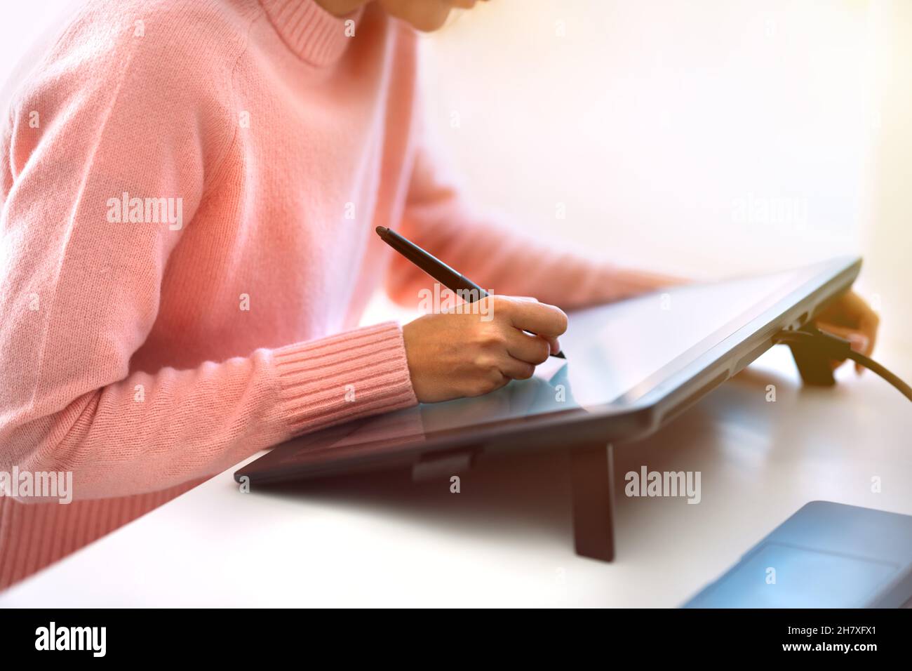 Woman graphic designer or photo editor working on digital graphic tablet Stock Photo