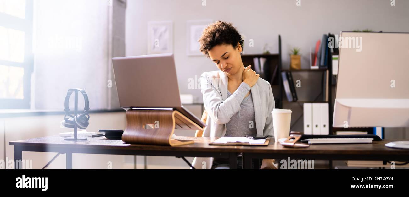 Neck Pain While Working At Computer. Bad Posture Stress Stock Photo