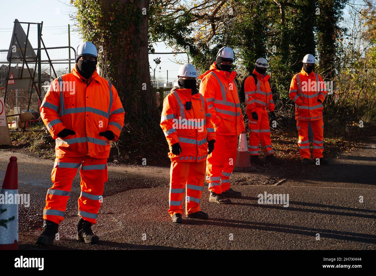 Aylesbury, Buckinghamshire, UK. 25th November, 2021. HS2 Security Guards outside their compound. Anti HS2 protesters were protesting along the Oxford Road today in Aylesbury about HS2 allegedly committing wildlife crimes as HS2 have felled mature trees that they believe had hibernating bats roosting in them. Although the Eastern Leg of the HS2 High Speed Rail has been cancelled by Boris Johnson, HS2 Ltd are continuing with their construction of Phase 1 of the HS2 High Speed Rail from London to Birmingham which is destroying swathes of the Chilterns, an Area of Outstanding Natural Beauty. Credi Stock Photo