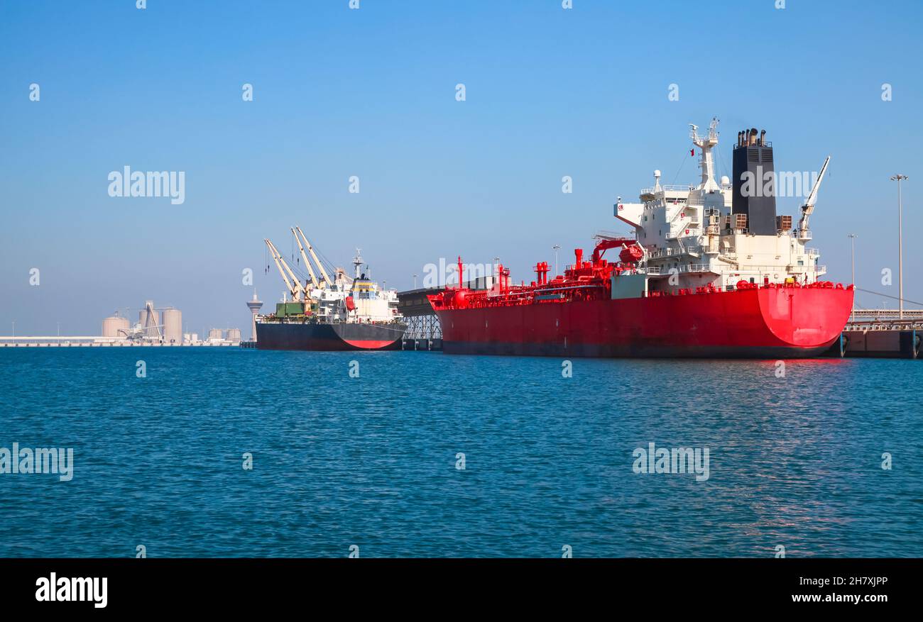Red tanker ship is loading in port of Saudi Arabia, stern view Stock Photo