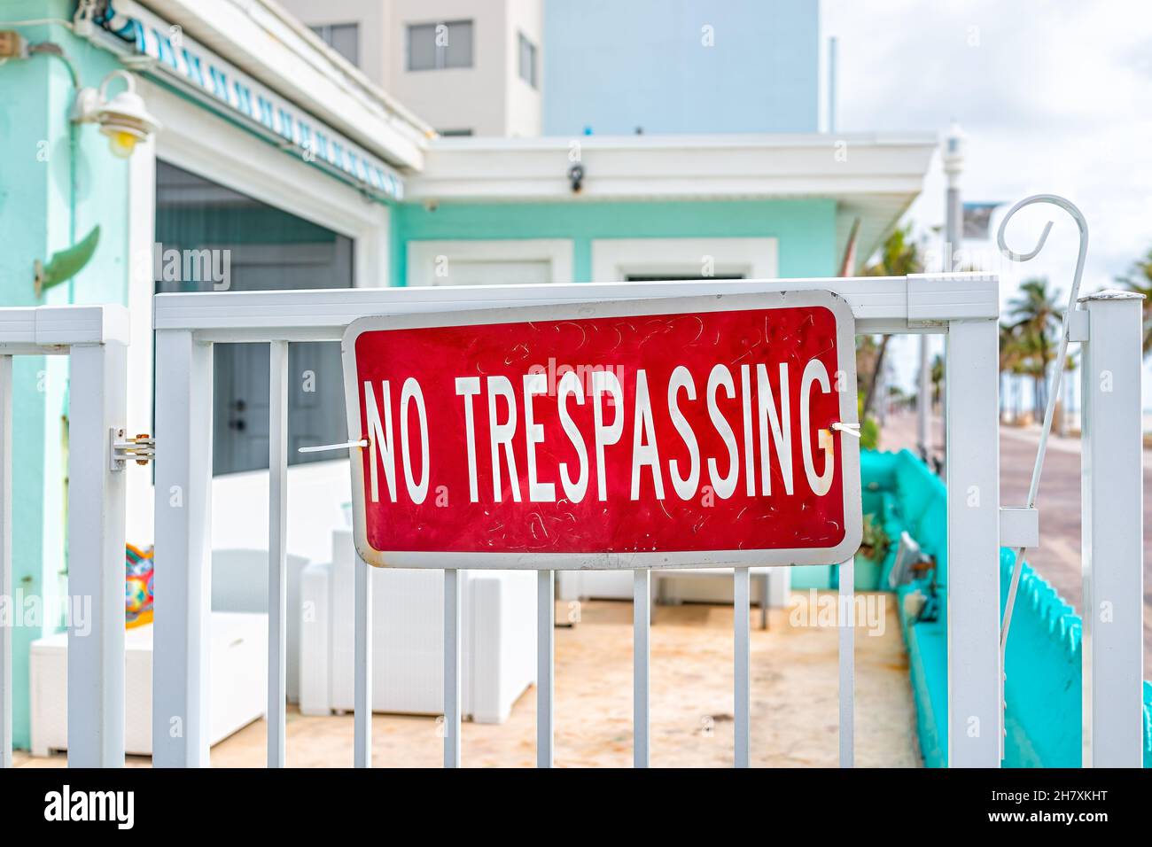 Hollywood, Miami Beach broadwalk in Florida and no trespassing sign art deco colorful apartment house building with turquoise green blue architecture Stock Photo