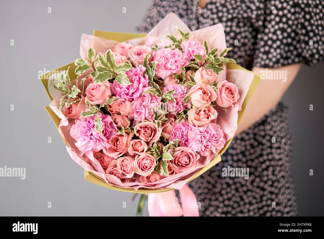 Large Beautiful bouquet of mixed flowers in woman hand. Floral shop concept . Beautiful fresh cut bouquet. Flowers delivery. Stock Photo