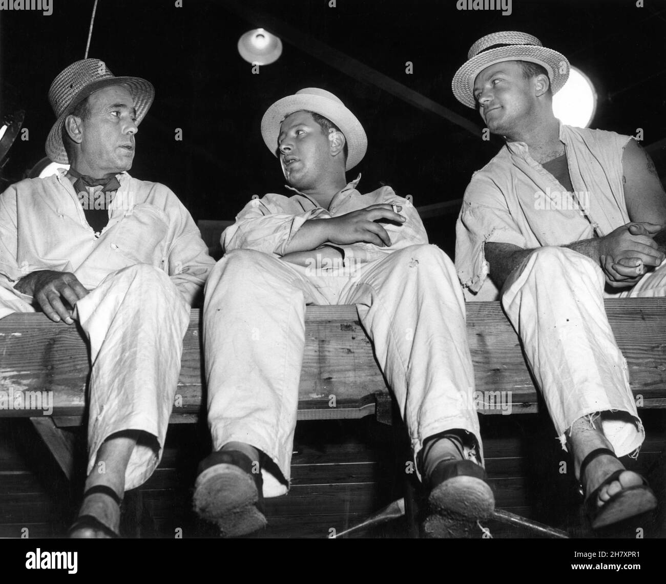 HUMPHREY BOGART ALDO RAY and PETER USTINOV on set candid during filming of WE'RE NO ANGELS 1955 director MICHAEL CURTIZ play Albert Husson costume design Mary Grant Paramount Pictures Stock Photo