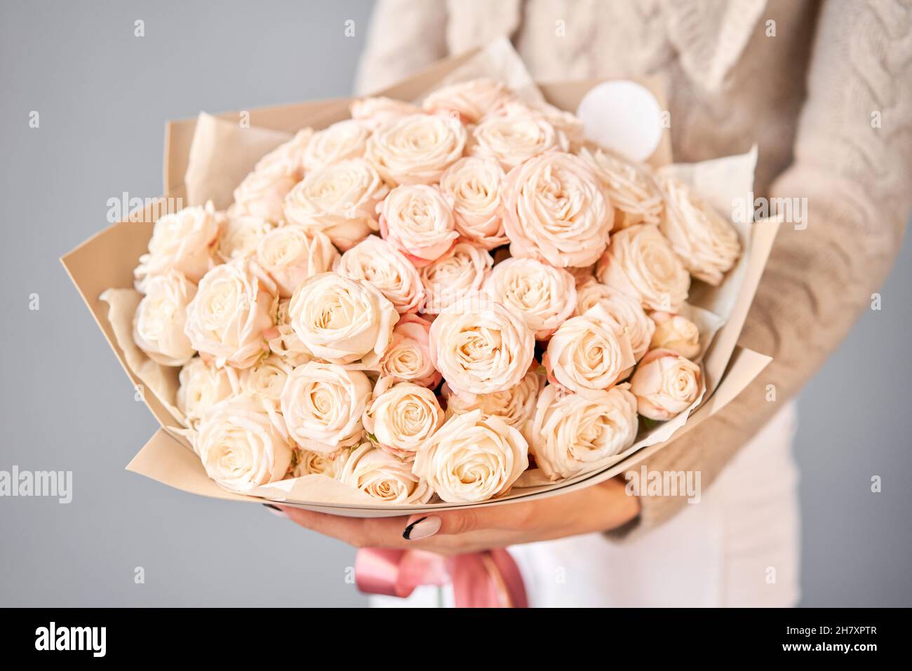 Floral carpet, flower texture, shop concept. Beautiful fresh blossoming flowers roses, spray roses. Blossom in vases and pails. Top view Stock Photo