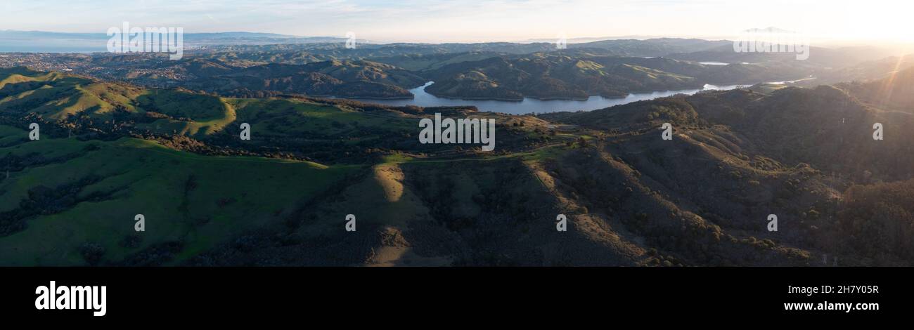 Early morning sunlight shines on the green hills of the east bay, near San Francisco Bay. These hills in California turn green during winter months. Stock Photo