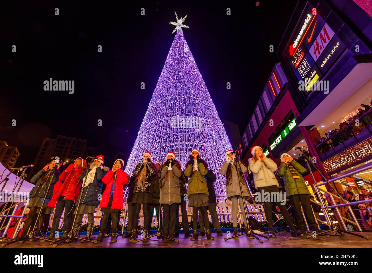 London, UK. 25th Nov, 2021. Winterfest, The Big Switch On, Wembley Park, UK. 25th November 2021.Chalkhill Primary School Choir at The Winterfest Big Switch On, Wembley Park. Returning to Wembley Park after a years hiatus, Wembley Park's free winter lights trail, Winterfest, is returning for 2021. Celebrating togetherness, this year's Christmas lights theme will be 'Reunited in Light', and will feature returning favourites as well as brand-new commissions and new art installations. Credit: amanda rose/Alamy Live News Stock Photo