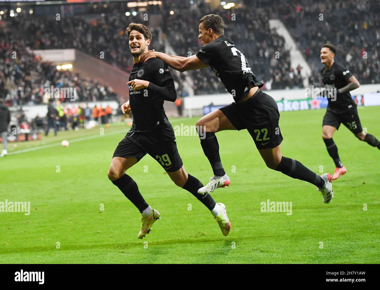 Frankfurt, Germany. 25th Nov, 2021. 25 November 2021, Hessen, Frankfurt/Main: Football: Europa League, Eintracht Frankfurt - FC Royal Antwerp, Group Stage, Group D, Matchday 5 at Deutsche Bank Park. Frankfurt's goal scorer Goncalo Paciencia (l-r), Timothy Chandler and Lucas Silva Melo cheer after the goal to equalise 2-2. Photo: Arne Dedert/dpa Credit: dpa picture alliance/Alamy Live News Stock Photo