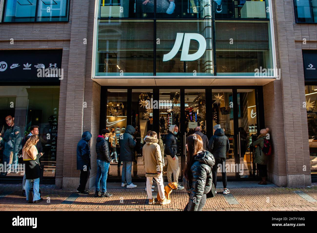 Amsterdam, Netherlands. 25th Nov, 2021. People are seen waiting to enter in  the JD store at Kavelstraat ahead of Black Friday with the shopping centre  looking emptier compared to other years. Credit: