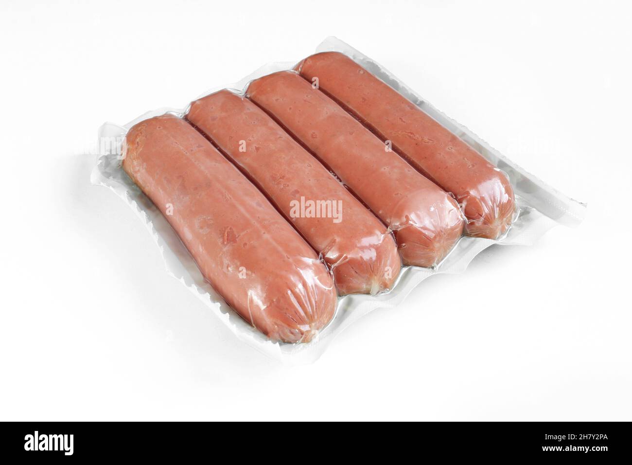 Sausages in plastic wrap package isolated on white background Stock