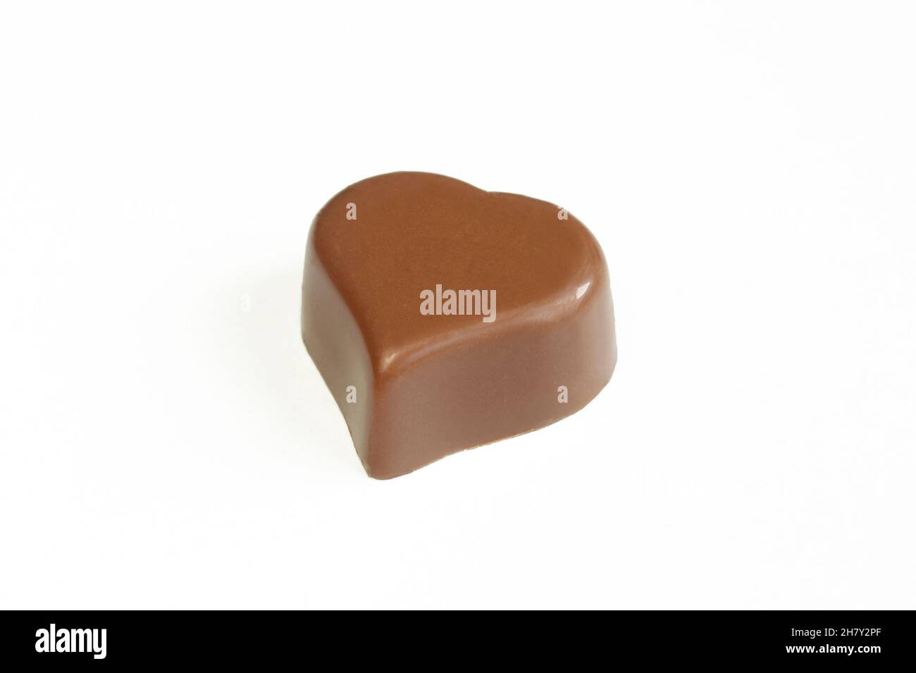 One chocolate heart isolated on white background. Tasty romantic treat Stock Photo