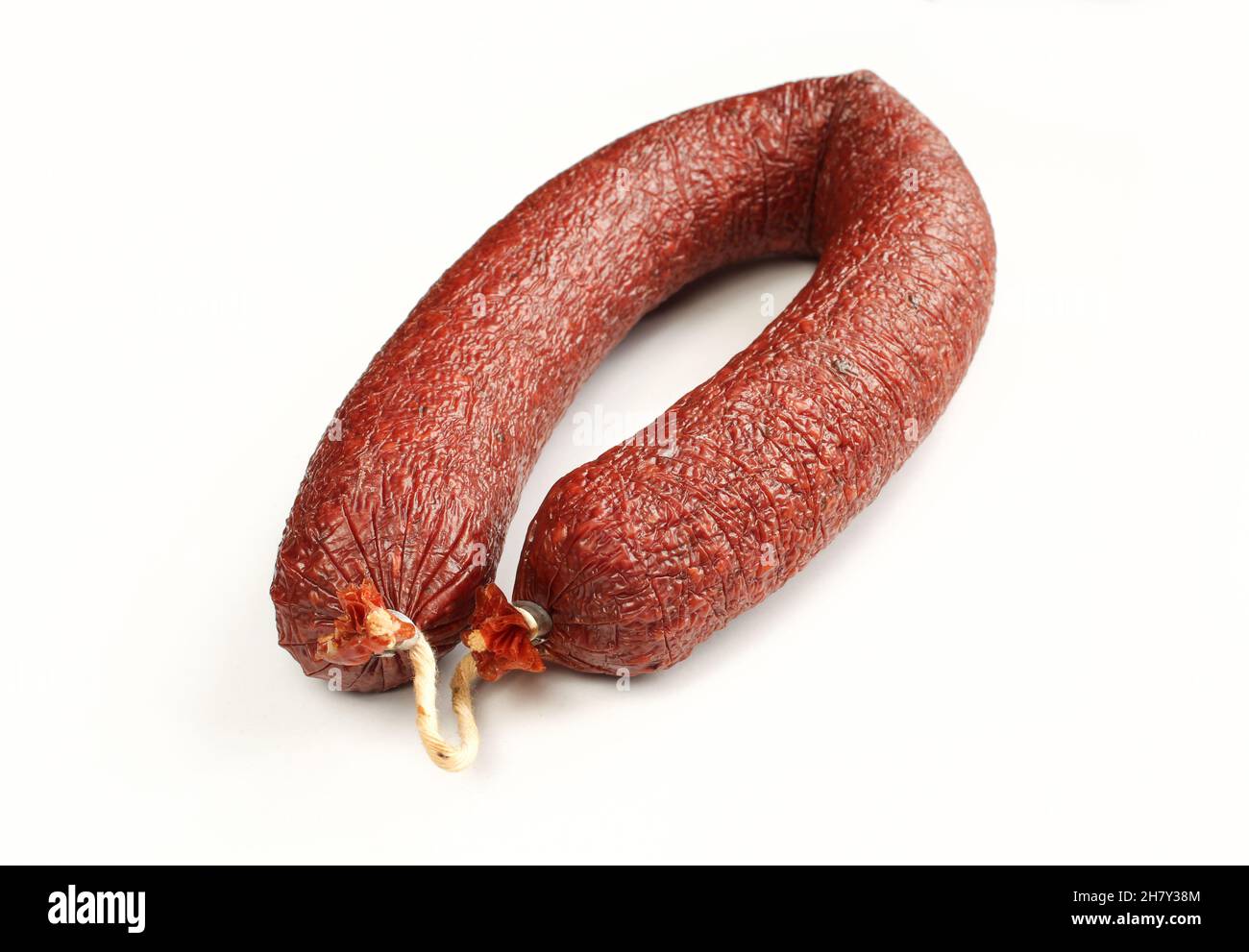 Smoked beef sausage isolated on white background. Delicious traditional meat Stock Photo