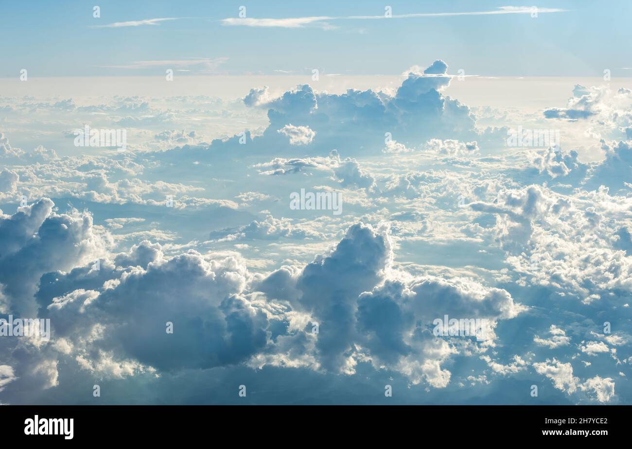 View over the clouds at high altitude with clusters of Cumulus Nimbus Stock Photo