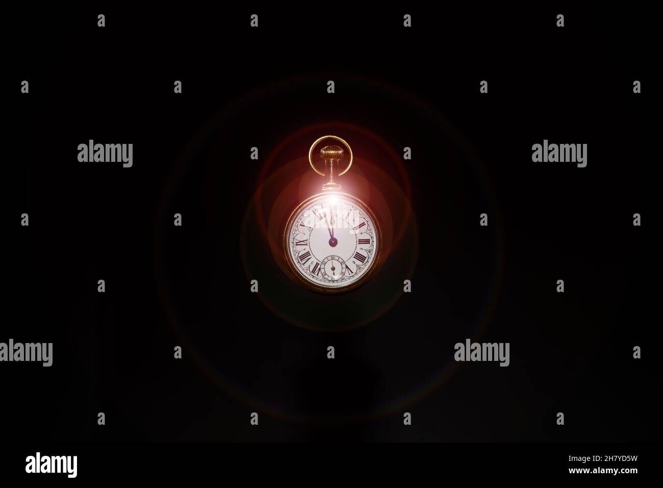 Classic Pocket Watch with flare of light at midnight Stock Photo