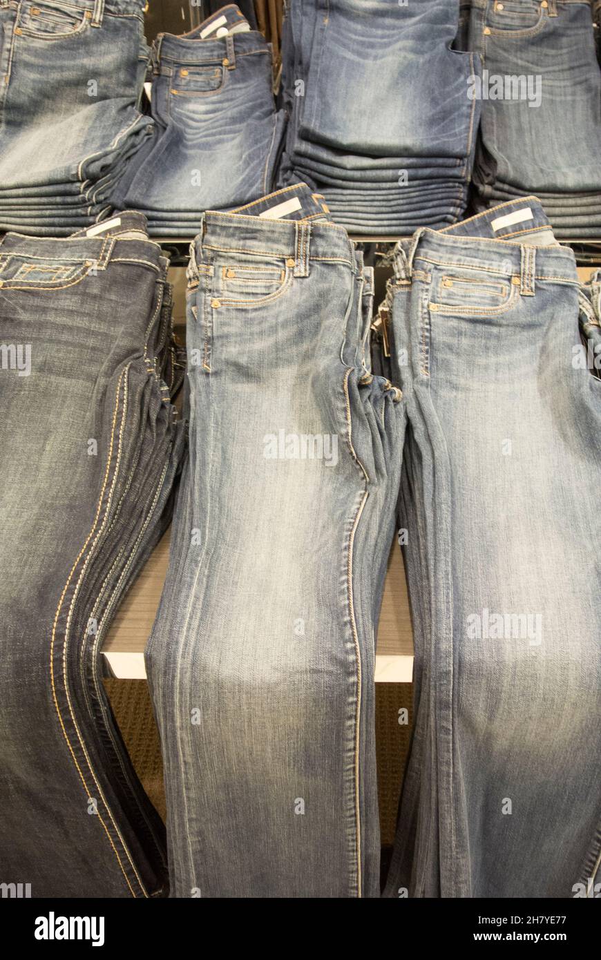 Store Display - Jeans Folded and Stacked on Table Stock Photo