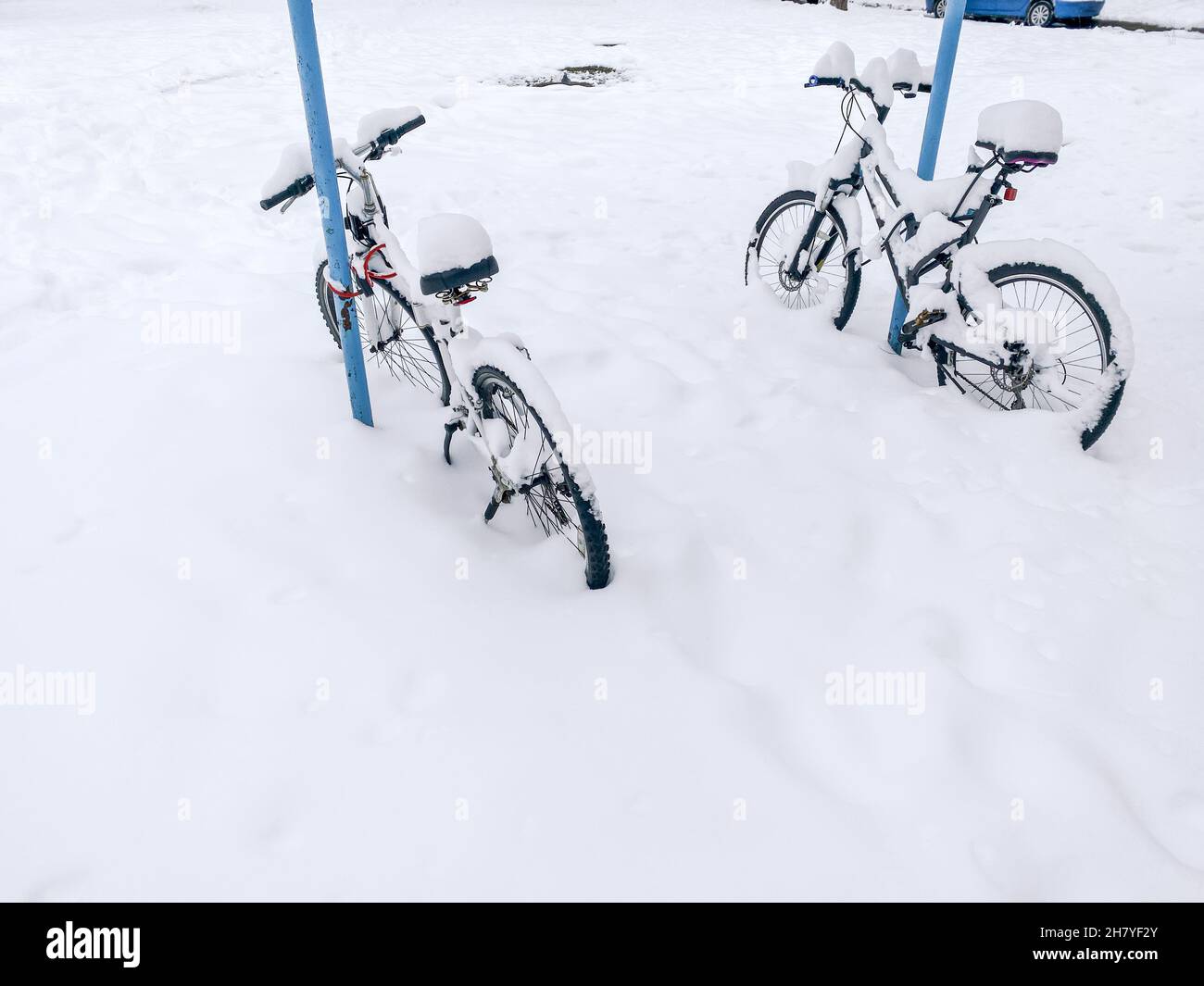 two bicycles parked in a snowdrift. winter season. Stock Photo