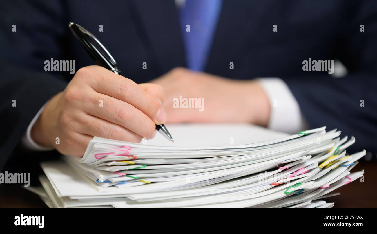 Businessman's hand holding a bundle of papers Stock Photo Alamy