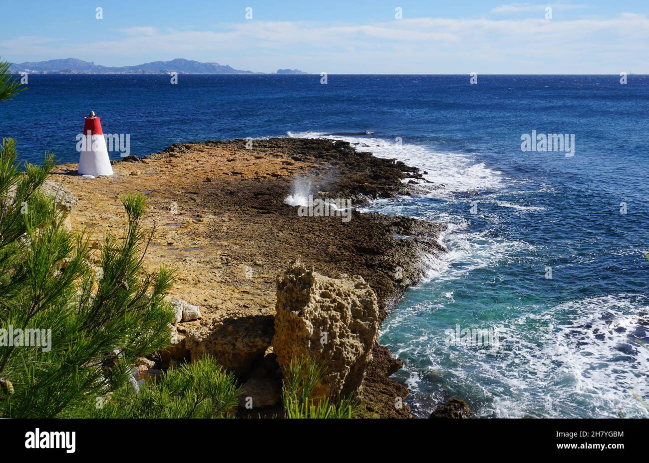 colorful red white lighthouse on mediterranee coast france Stock Photo
