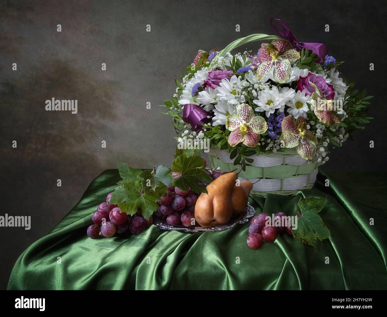 Still life with basket of flowers and fruits Stock Photo - Alamy