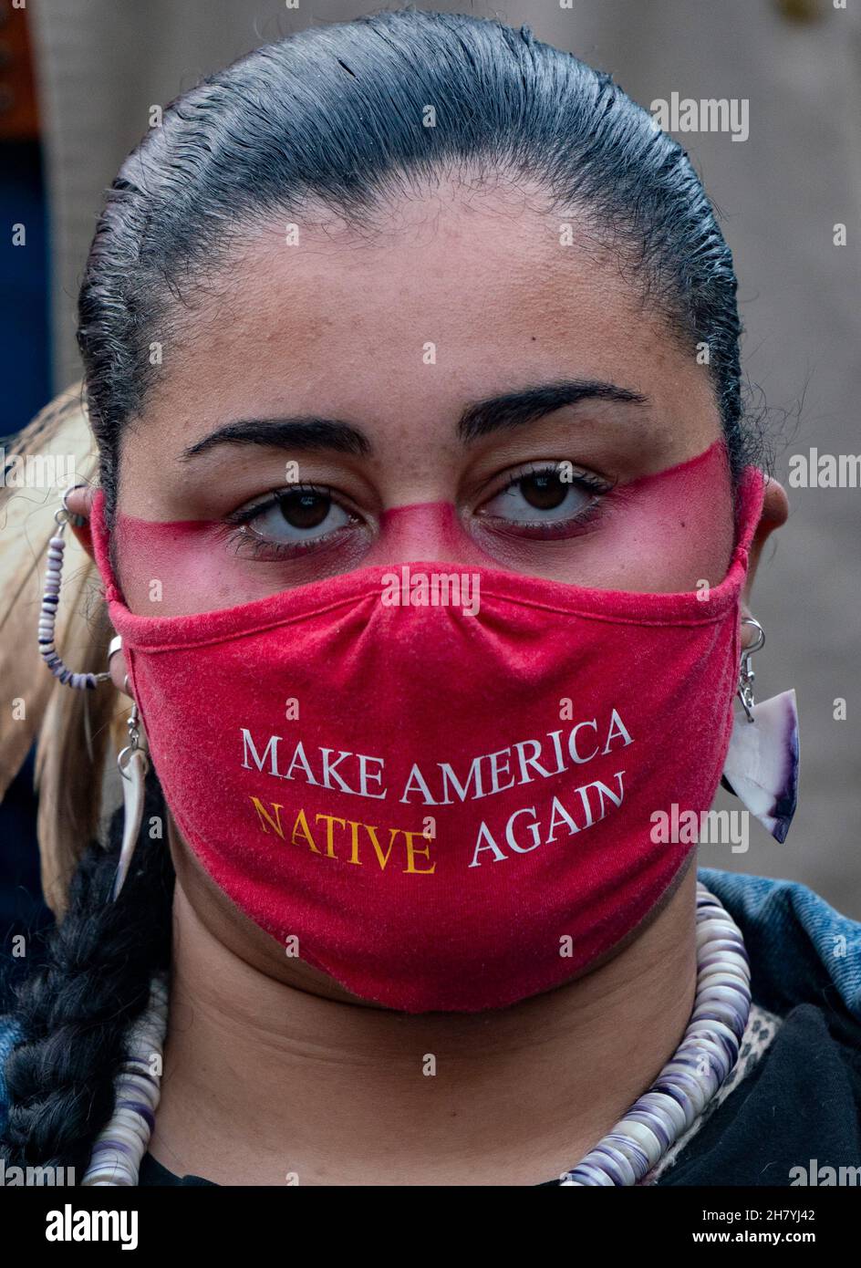 November 25, 2021, Plymouth, Massachusetts, USA: A demonstrators wearing Make America Native Again face mask, rallies to commemorate a National Day of Mourning at downtown Plymouth. A red handprint is a symbol that is used to indicate solidarity with missing and murdered Indigenous women and girls in North America. More than thousand people rally to commemorate a National Day of Mourning in Plymouth. More than thousand demonstrators rally to commemorate a National Day of Mourning organized by the United American Indians of New England n Thanksgiving Day. It's the 52nd year that the Uni Stock Photo