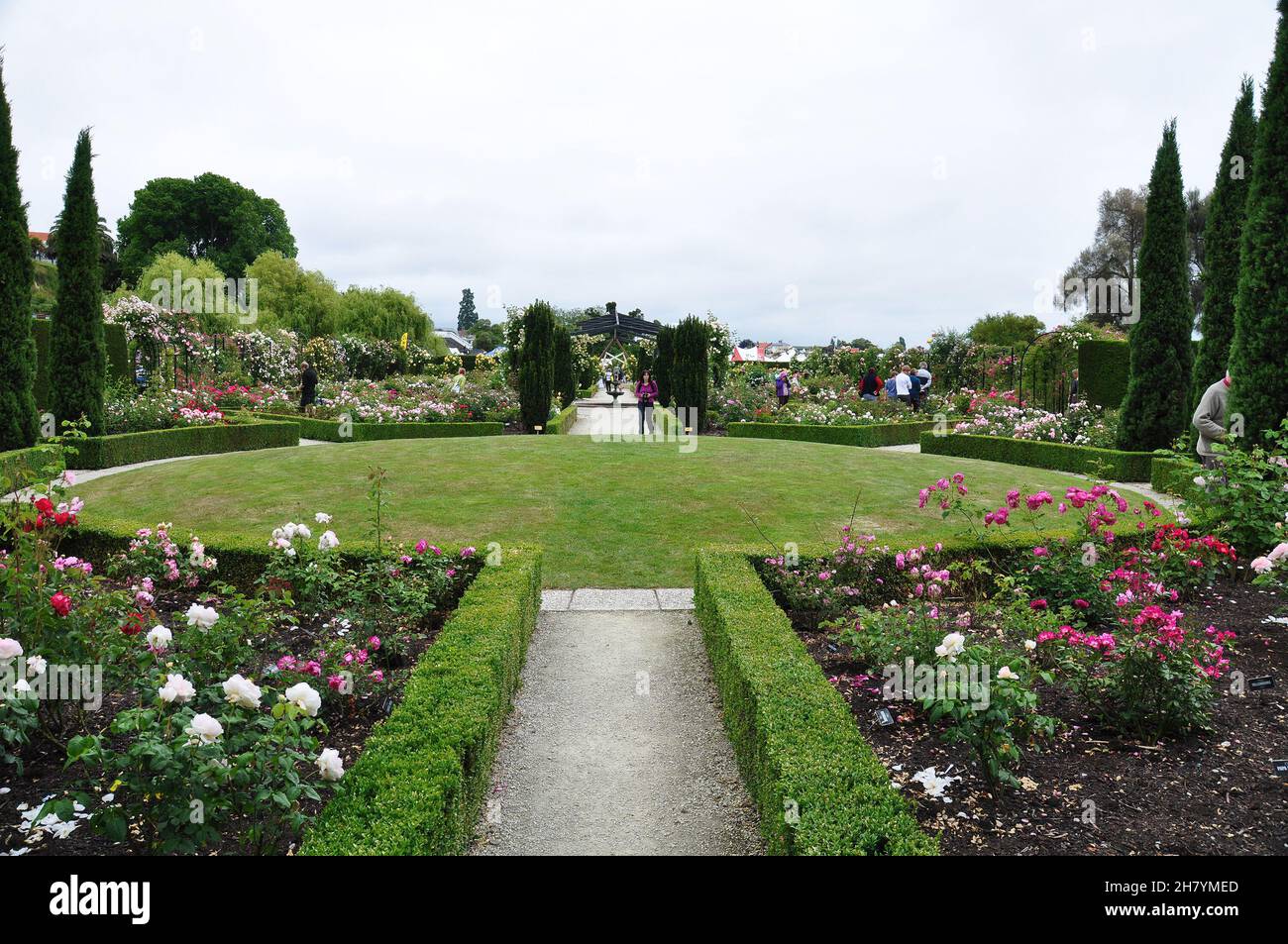 People visiting beautiful landscape of roses in Trevor Griffiths Public Rose Garden in Timaru, New Zealand on Nov 28, 2010 Stock Photo