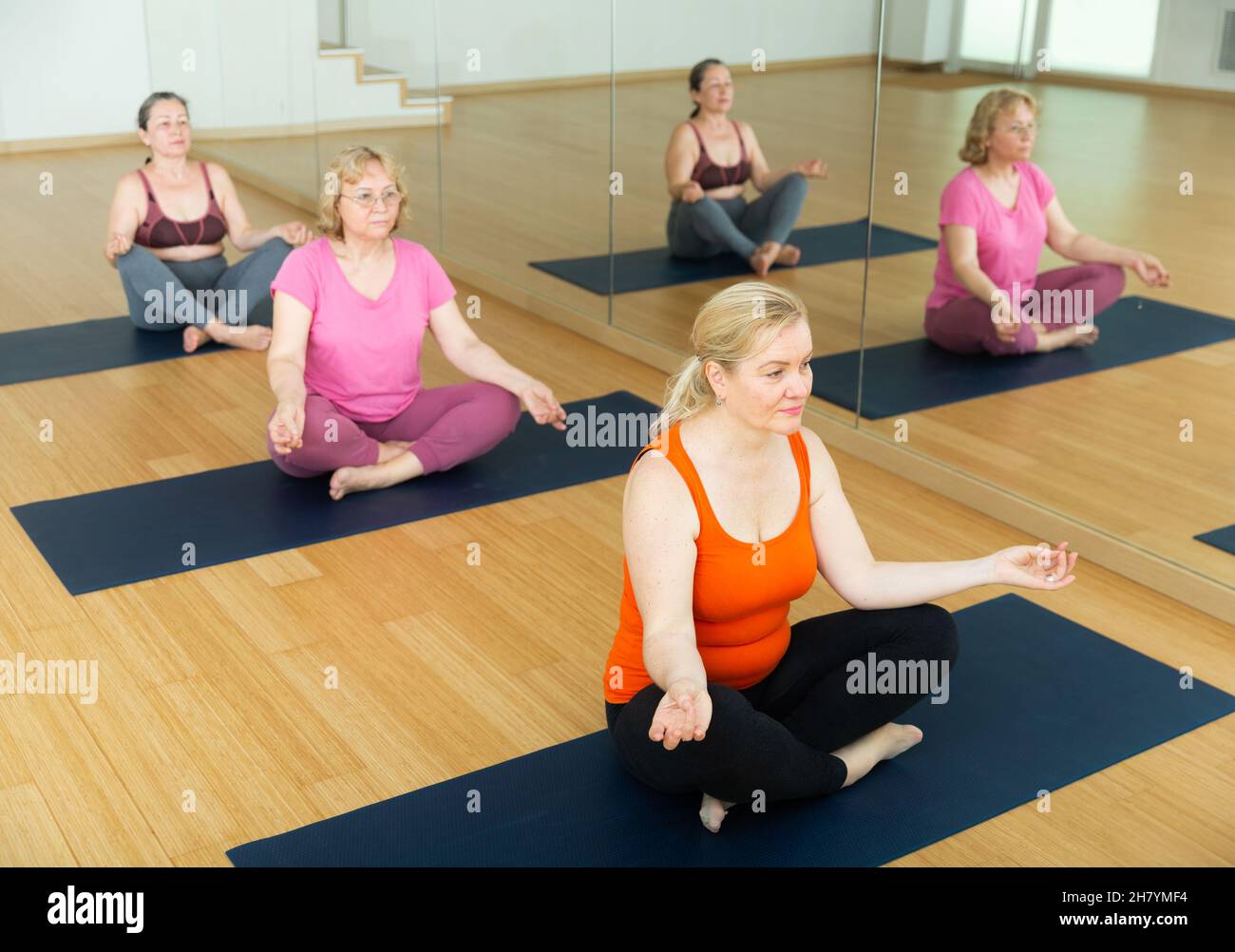 Group of mature woman making yoga meditation in lotus pose Stock Photo ...