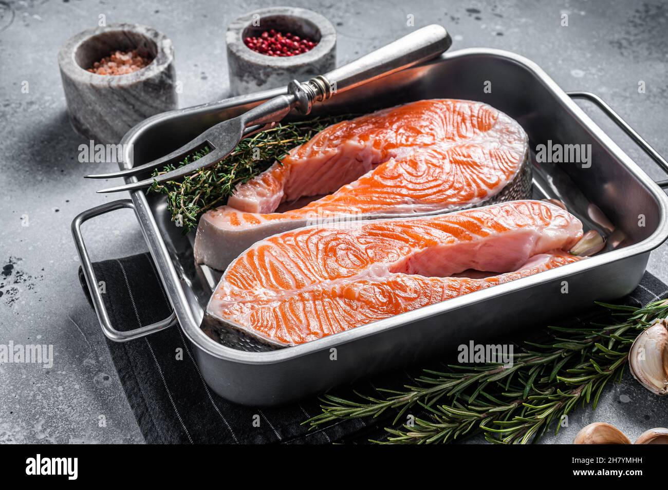 Raw Salmon Fish Steaks prepared for cooking with thyme and rosemary ...