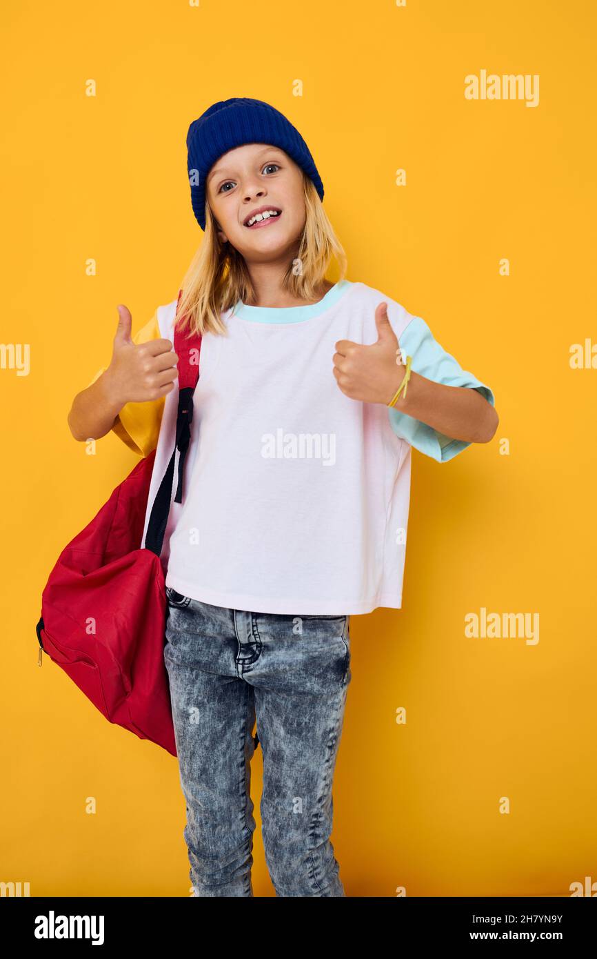 cute girl showing thumbs up school yellow background Stock Photo - Alamy