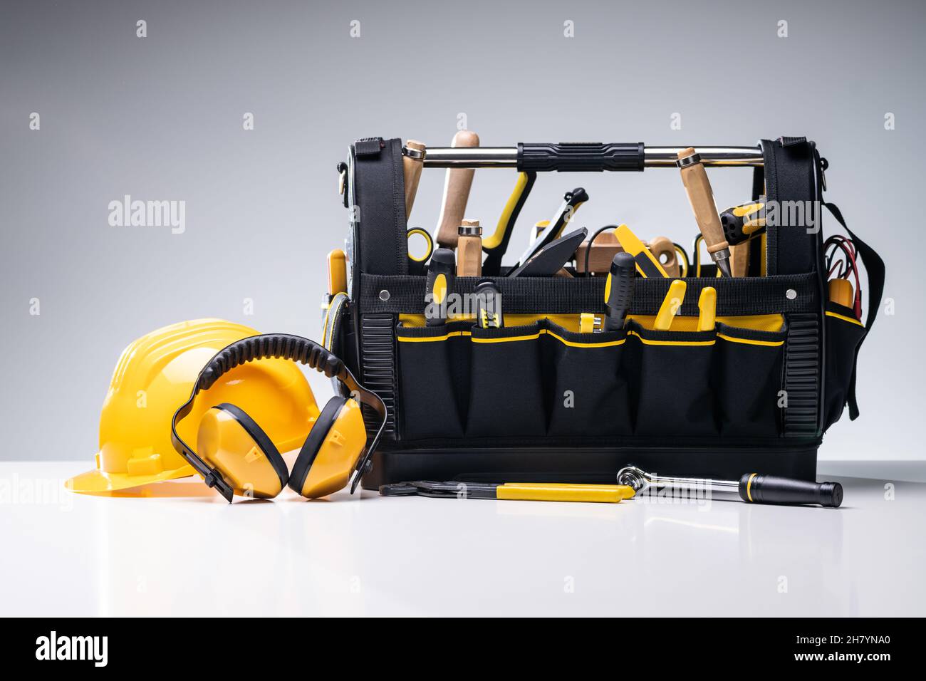 Various Manual Tools And Hardware In Toolbox On Gray Background Stock Photo