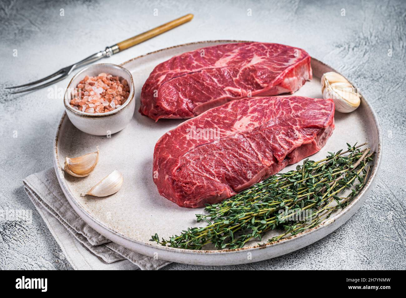 Raw Oyster Top Blade or flat iron roast beef meat steaks on a plate