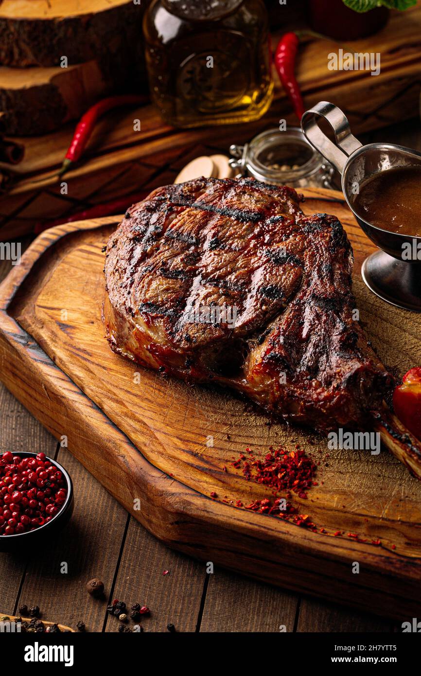 Grilled beef tomahawk steak with pepper sauce Stock Photo