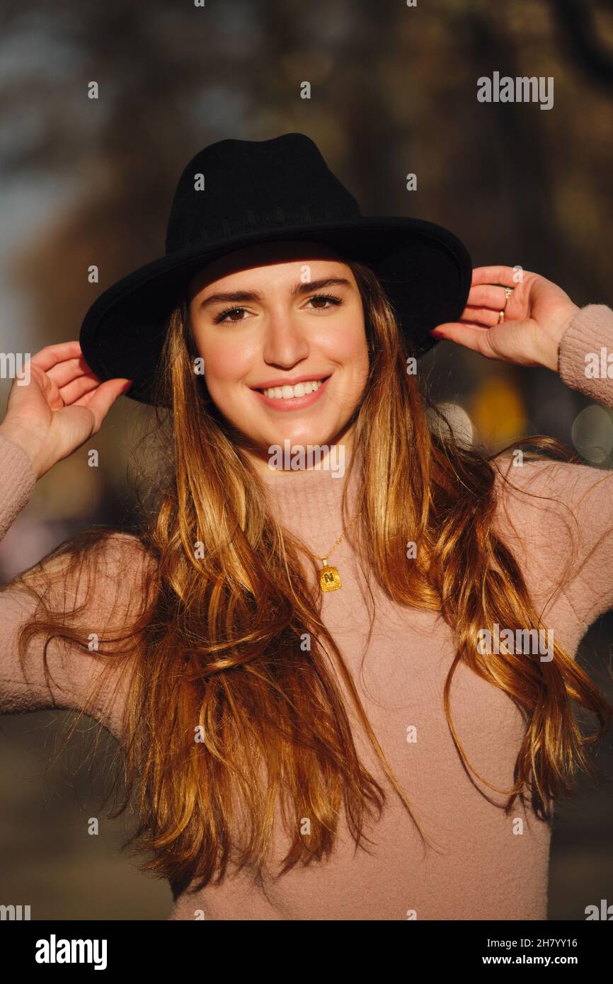 Woman smiling while standing outdoors. Stock Photo
