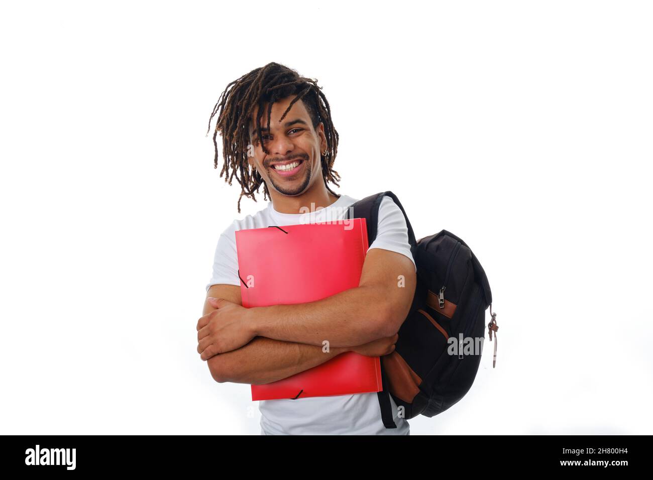 Smiling man wearing a backpack and holding a folder while standing on an isolated background. Stock Photo