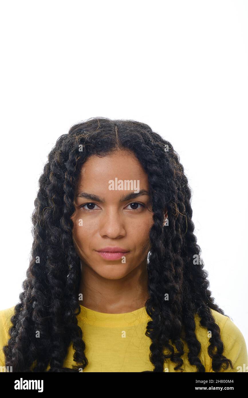Close up view of a latin woman looking at camera with a serious expression on her face. Stock Photo