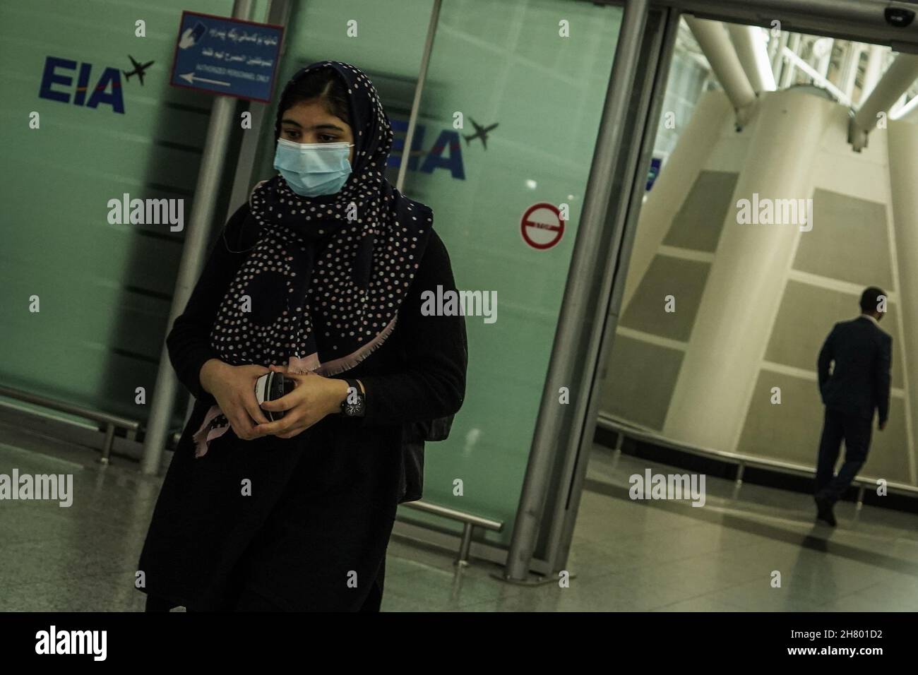 Erbil, Iraq. 26th Nov, 2021. An Iraqi young woman walks through the arrivals terminal at Erbil International Airport, after the landing of a repatriation flight carrying migrants who were stranded for weeks along the Polish-Belarusian borders. Credit: Ismael Adnan/dpa/Alamy Live News Stock Photo