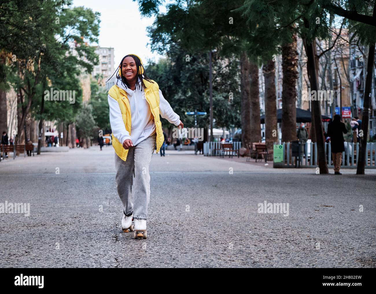 Woman listening music while roller skating Stock Photo Alamy