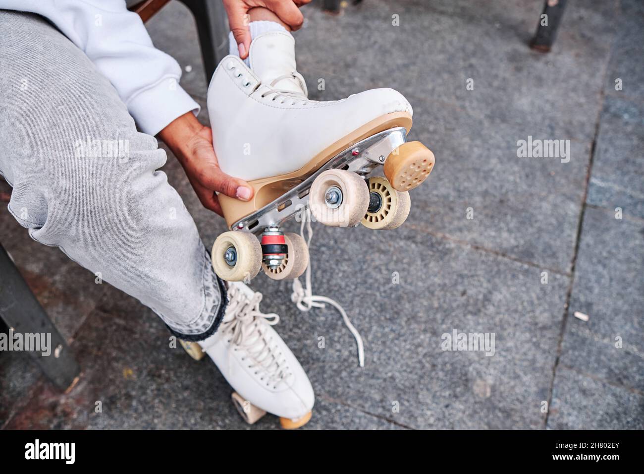 Woman taking off her roller skates Stock Photo Alamy