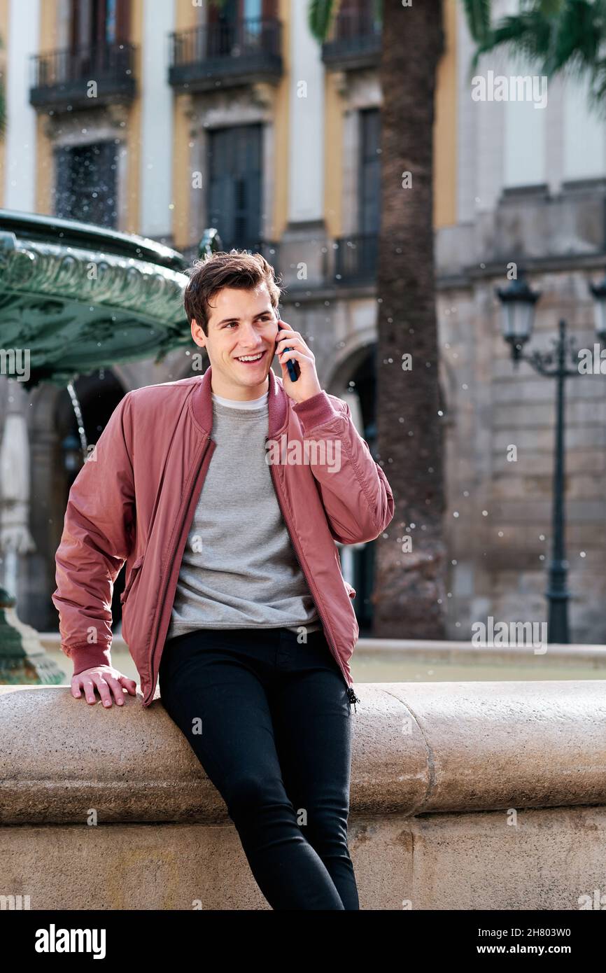 Young man talking on the phone outdoors. Stock Photo