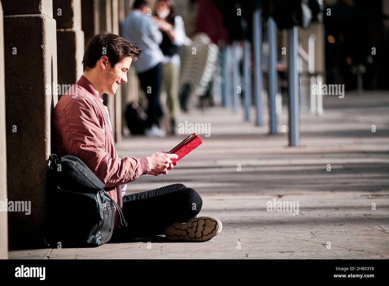 Young man using a digital tablet outdoors. Stock Photo