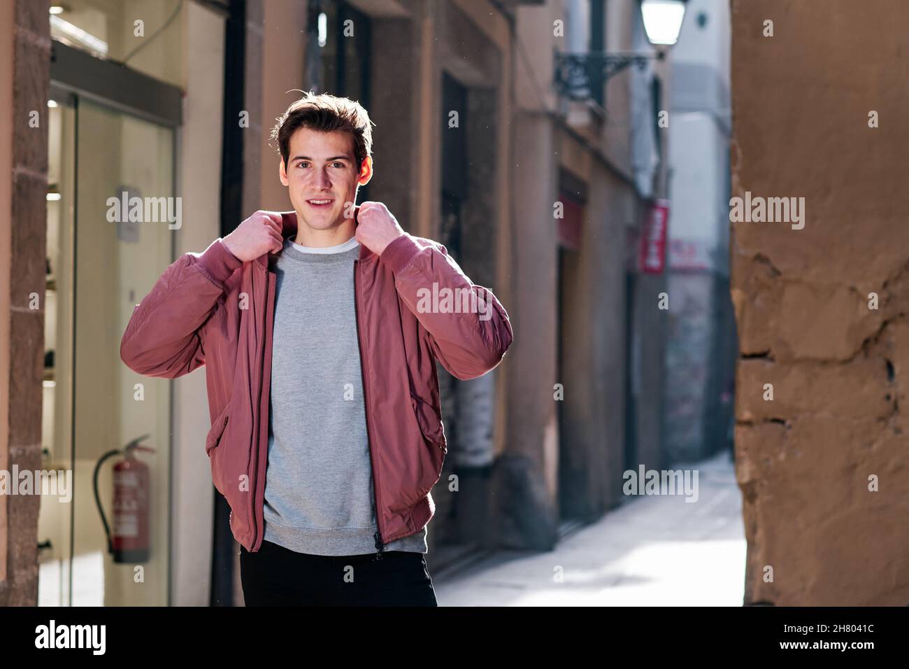 Young man standing outdoors on the street. Stock Photo