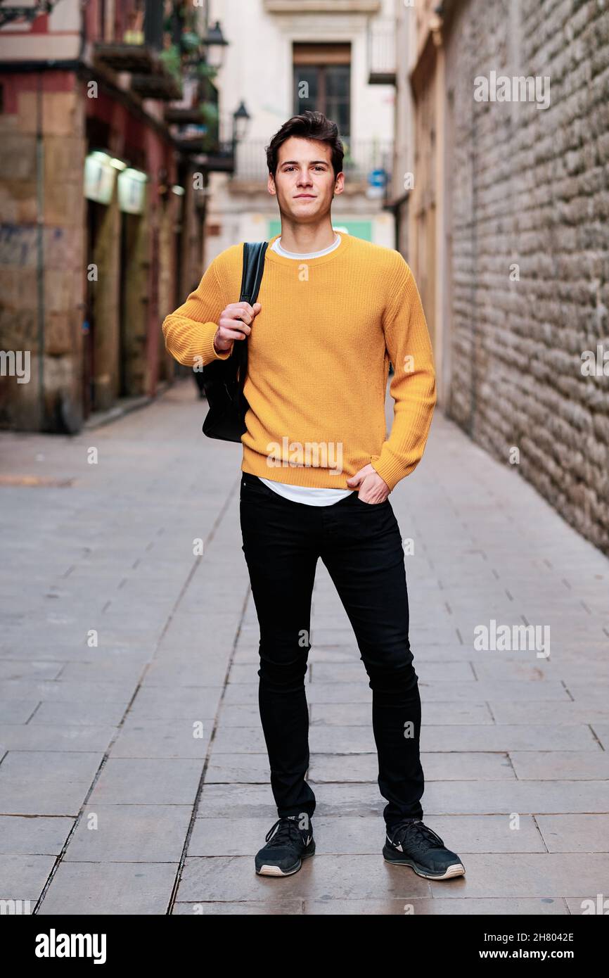 Young man standing outdoors on the street. Stock Photo