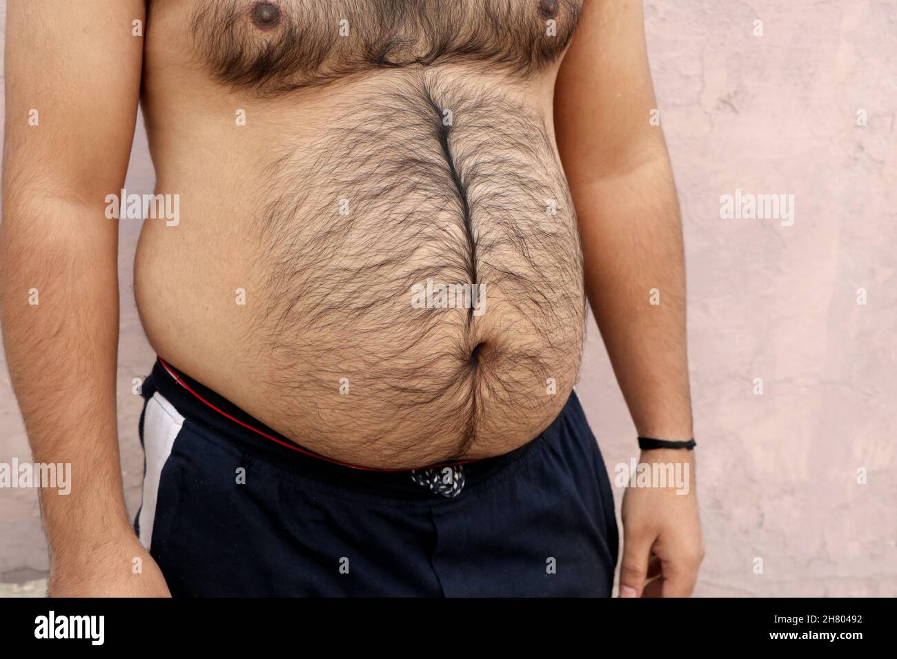 A portrait of a asian fat man show out his body and big belly. Concept of  Obesity Stock Photo - Alamy