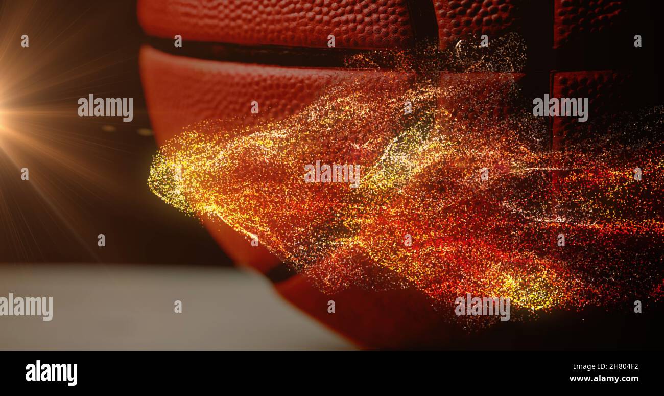 Image of glowing orange particles moving over basketball Stock Photo