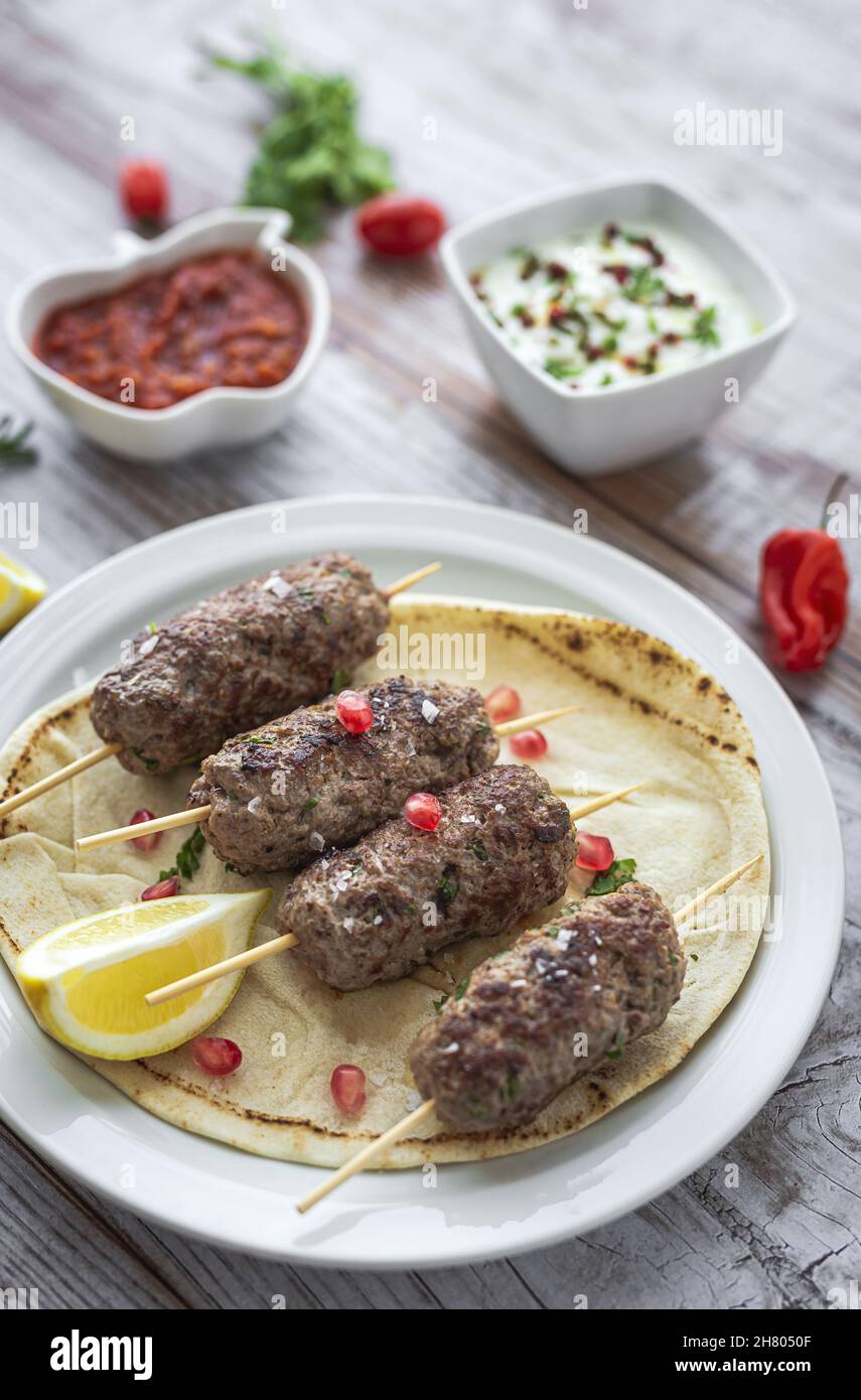 Traditional homemade kafta or kofta kebab beef and lamb with tomato