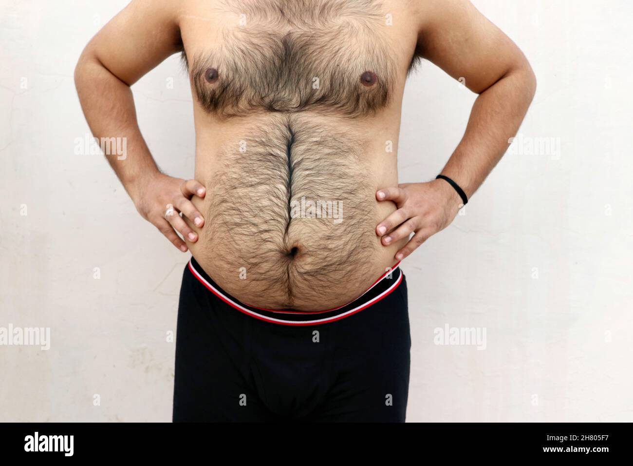 A portrait of a asian fat man show out his body and big belly. Concept of Obesity Stock Photo