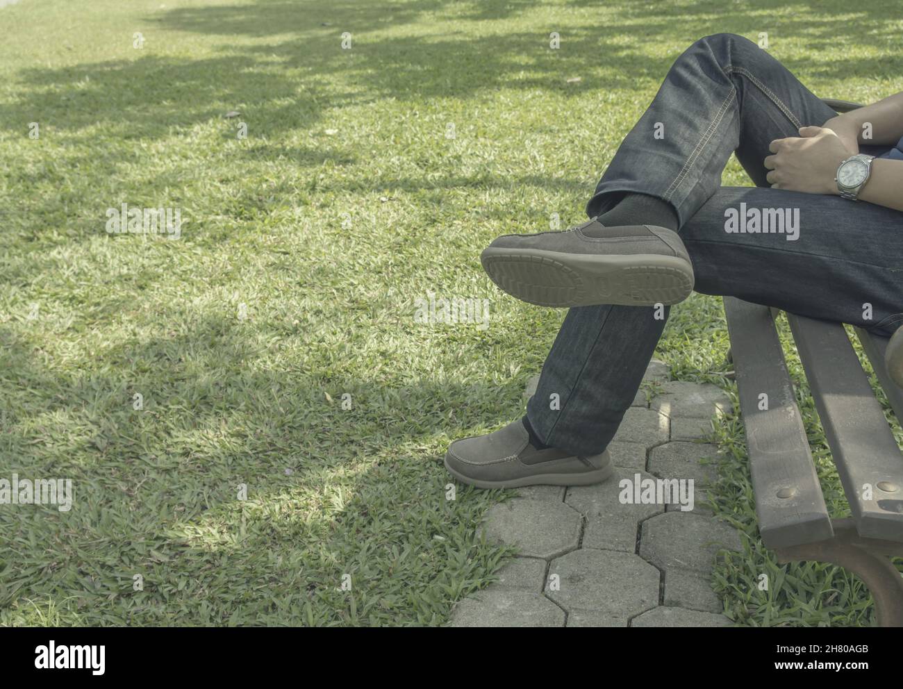 Sad man sitting alone in the park Stock Photo - Alamy