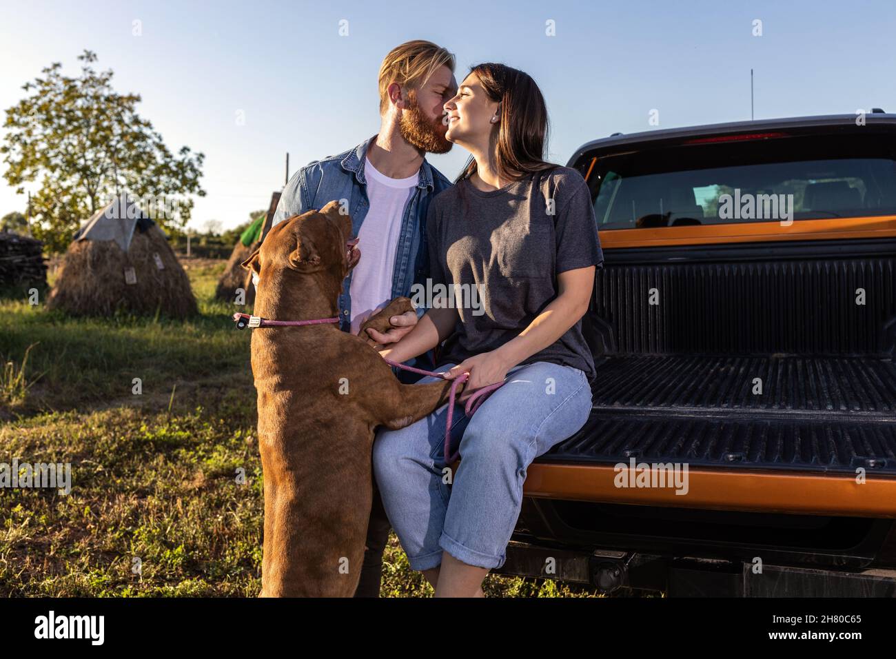 Cute young couple with a dog Stock Photo - Alamy