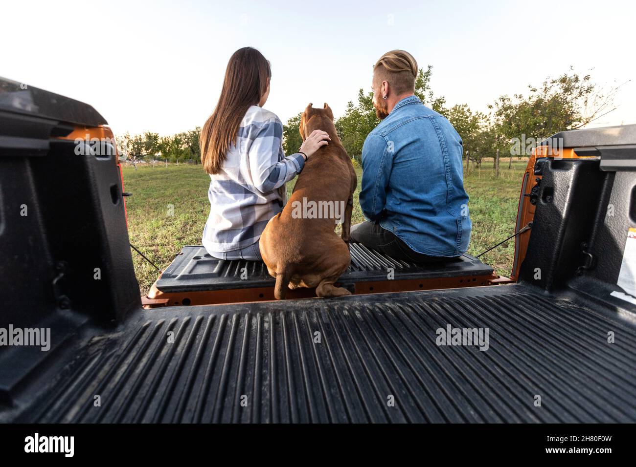 Cute young couple with a dog Stock Photo - Alamy