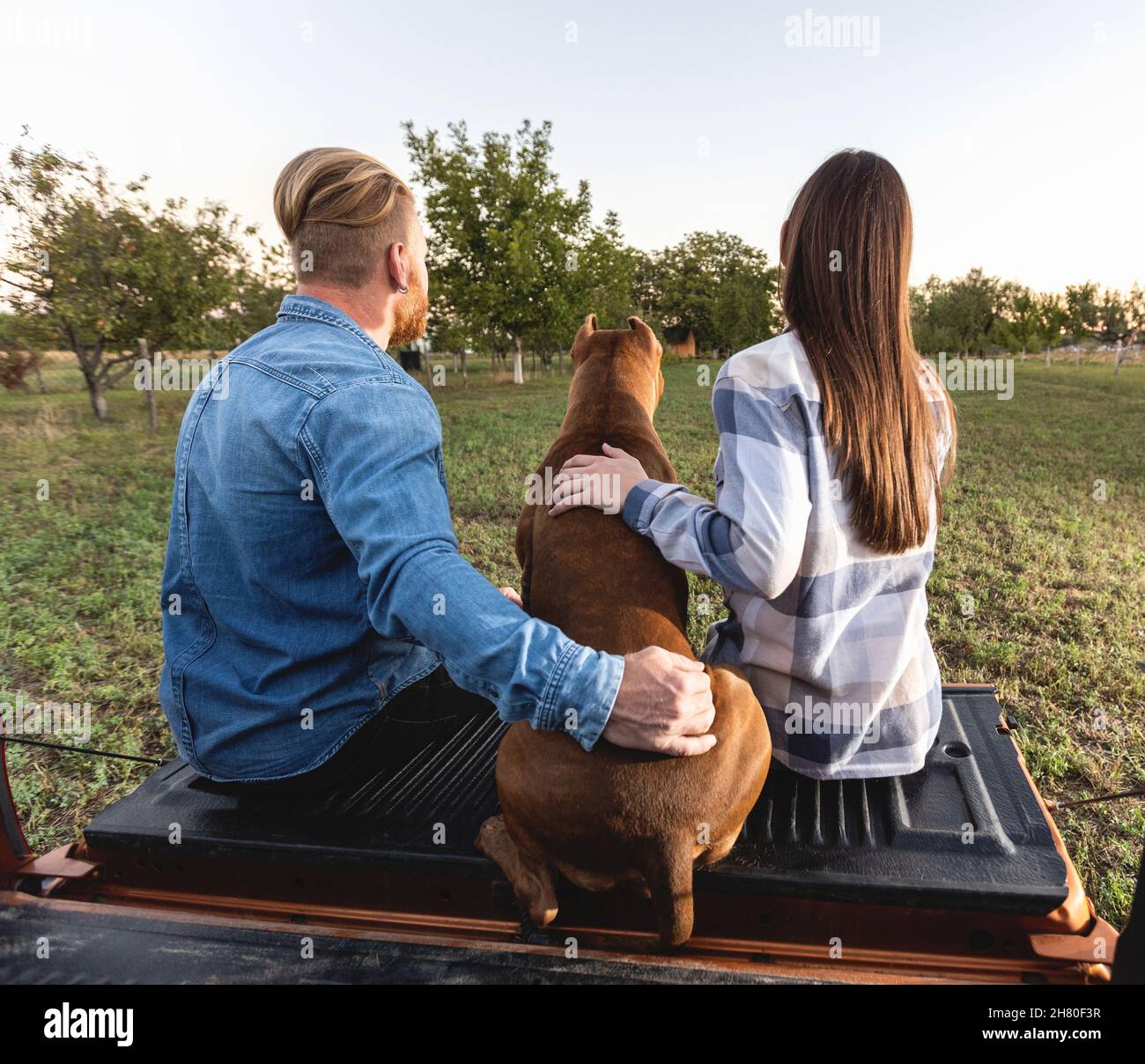 Cute young couple with a dog Stock Photo - Alamy